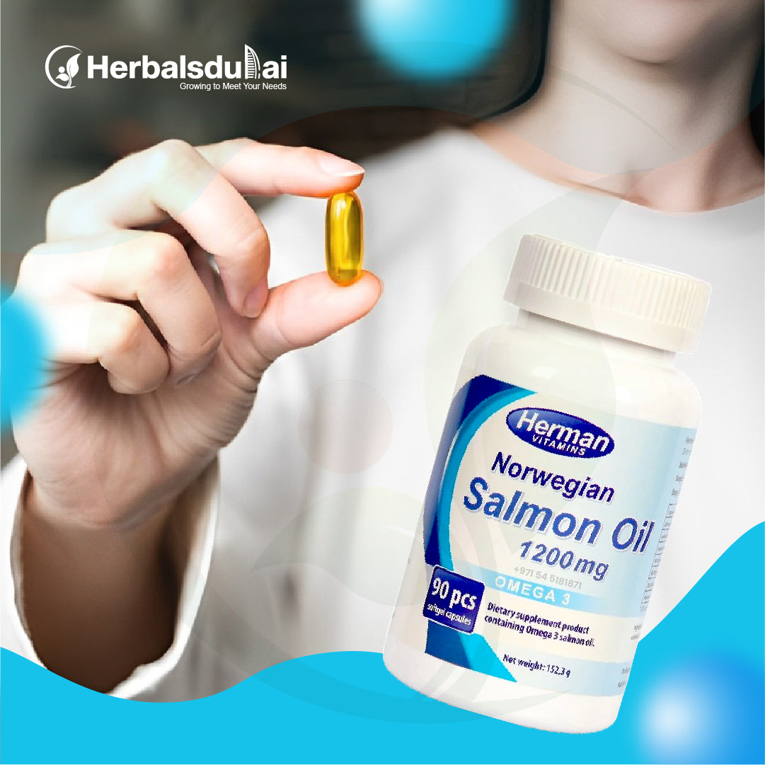 A person holding a salmon oil capsule, with a bottle of Herman Norwegian Salmon Oil 1200mg prominently displayed.